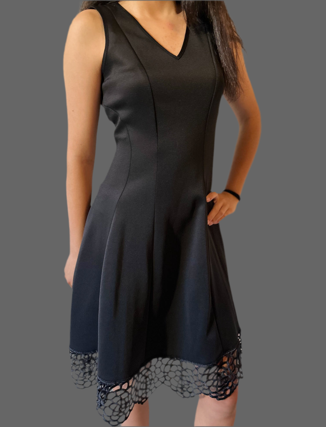 Black v neck dress with lace hem.